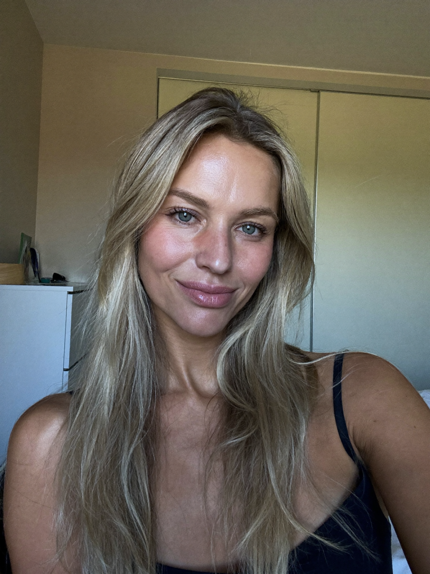 Woman with long blonde hair photographed at home